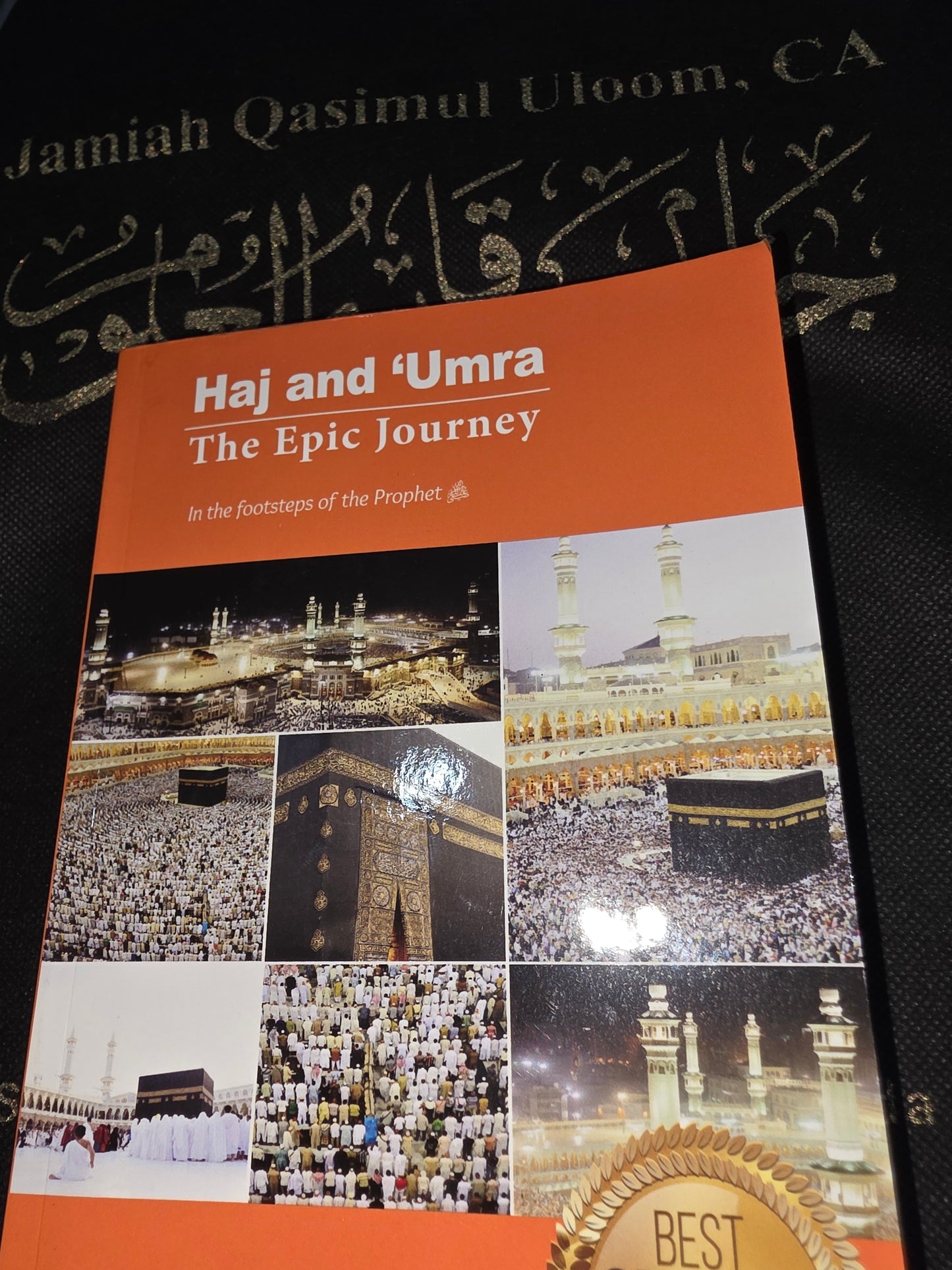 Book titled 'Hajj and Umrah: The Epic Journey' with images of religious sites on a black background.